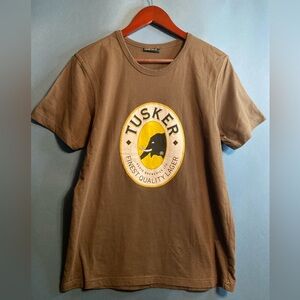 Large Brown Tusker Lager Brewery T Shirt. 
Made in Kenya. Very Unique Piece.